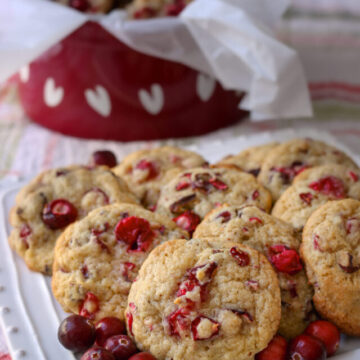 cranberry cookies on a plate as well as in a red tin with hearts.