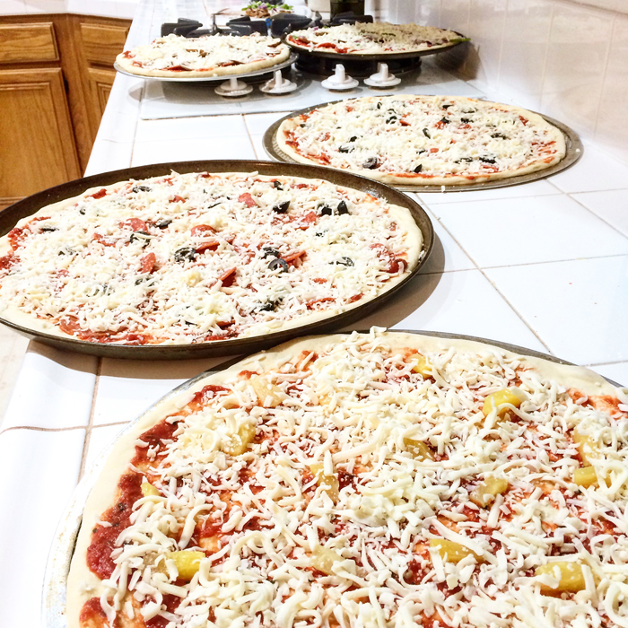 pizzas ready for baking sitting on counter