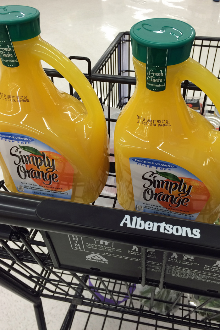 orange juice jugs in shopping cart