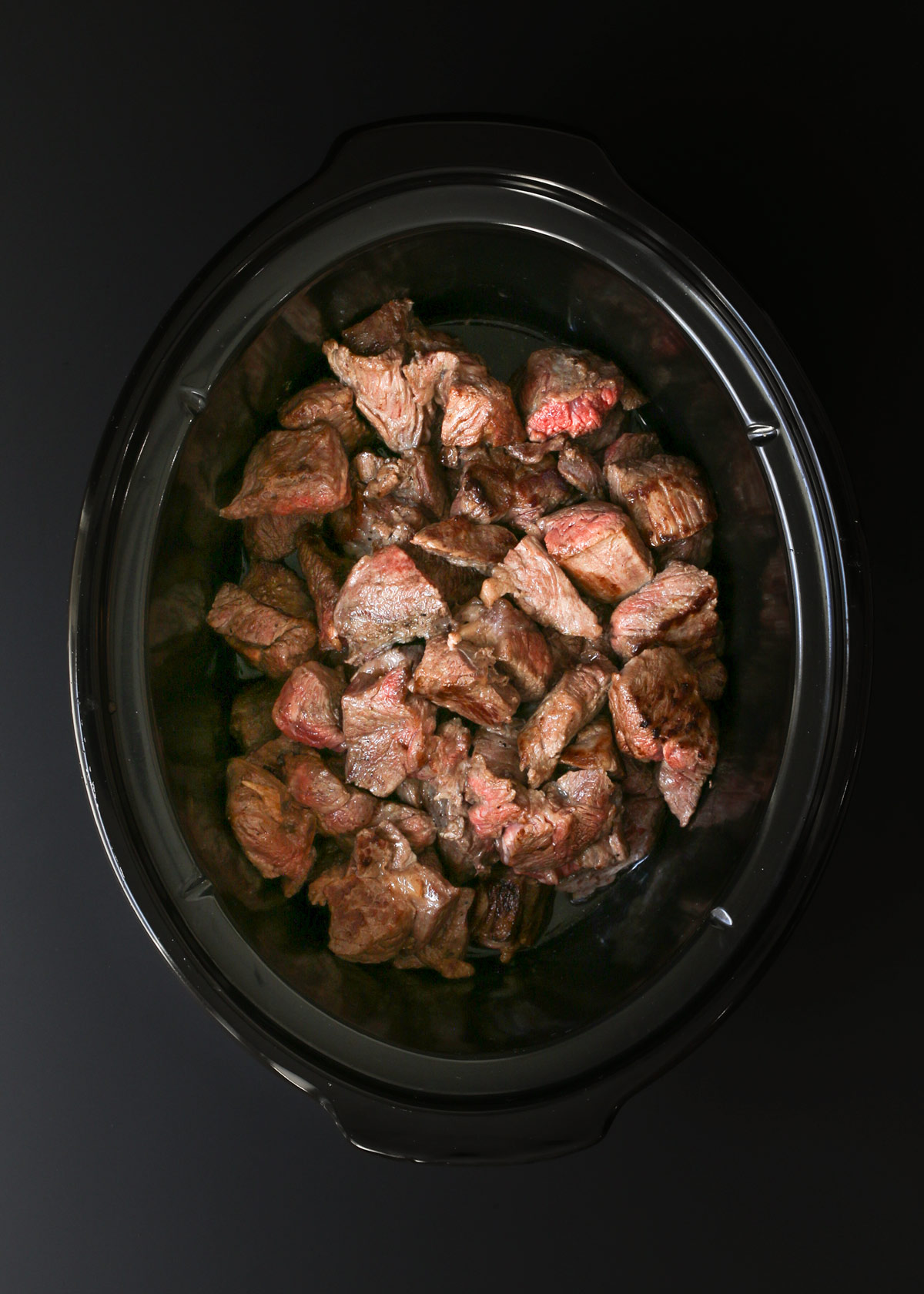 beef cubes transferred to the slow cooker.