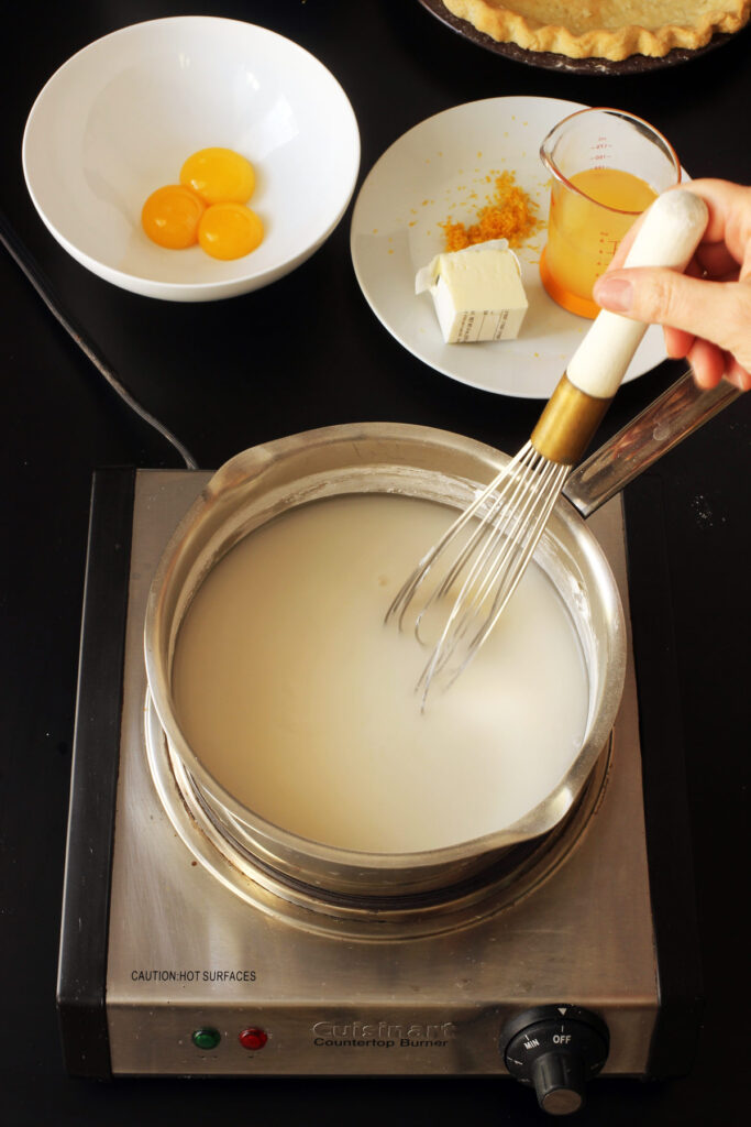 stirring sugar cornstarch and water in pot