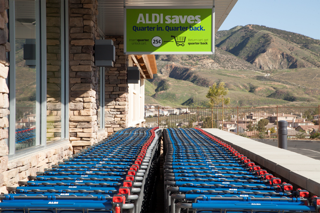 A line of carts on the side of an aldi store