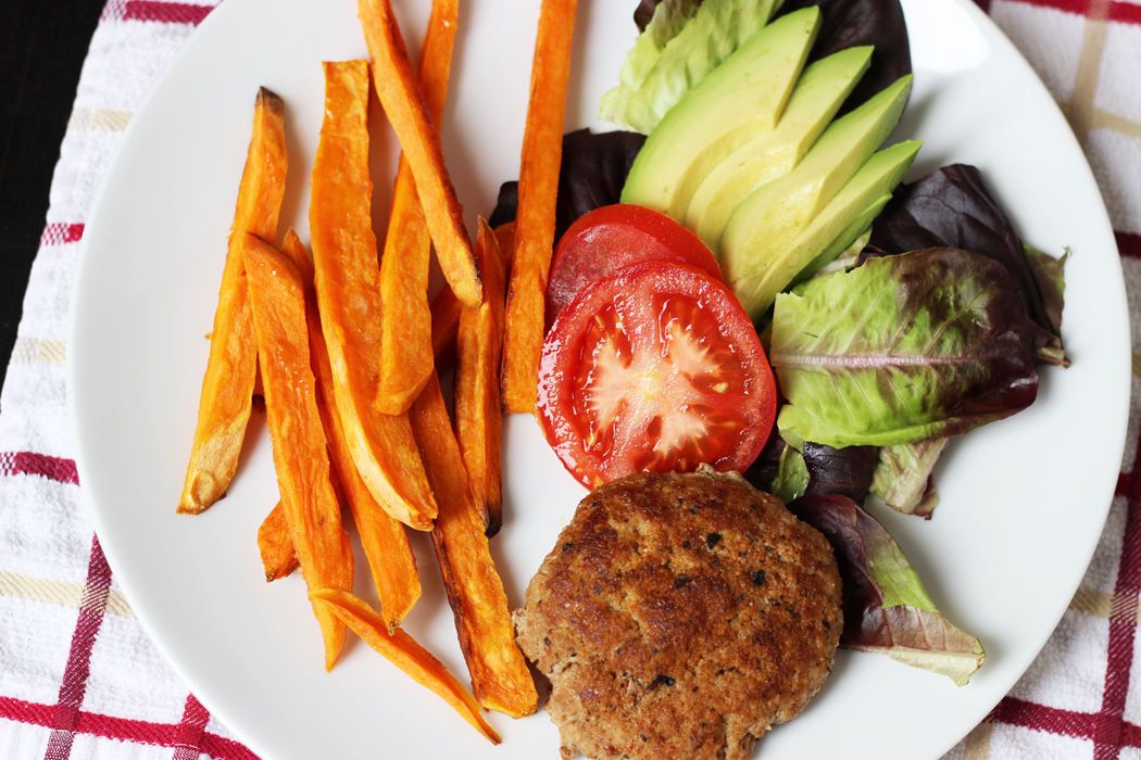 Sweet Potato Fries on a plate with a burger and a salad