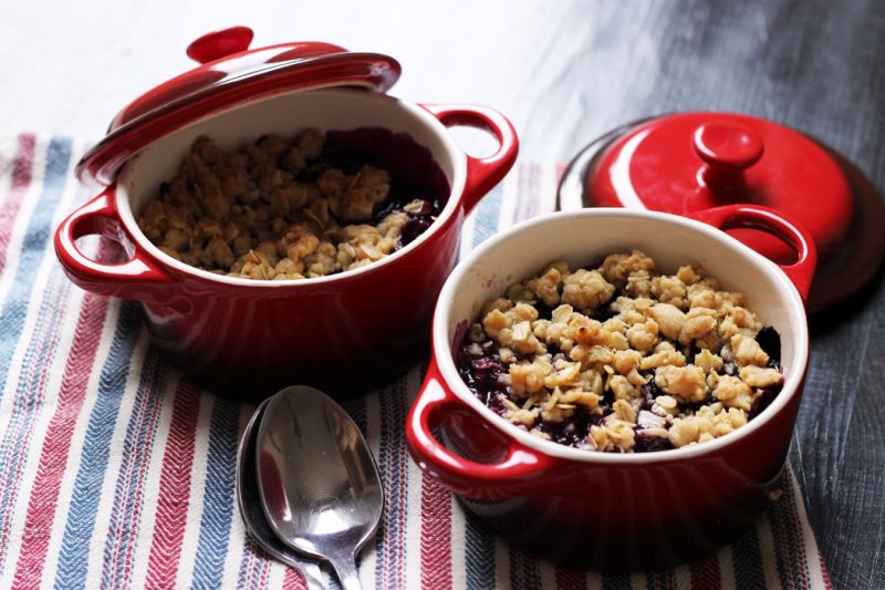 blueberry crumbles in ramekins on table