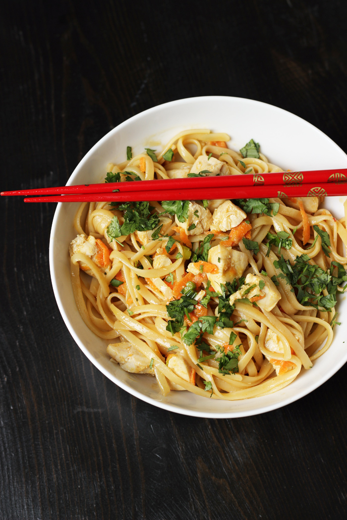 chopsticks resting on a bowl of noodles