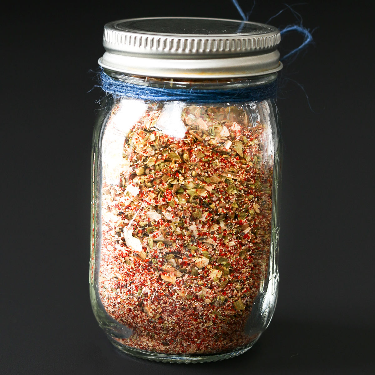 jar of taco spice mix with blue bakers twine around the neck.