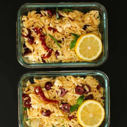 two meal prep containers with lemon orzo salad.