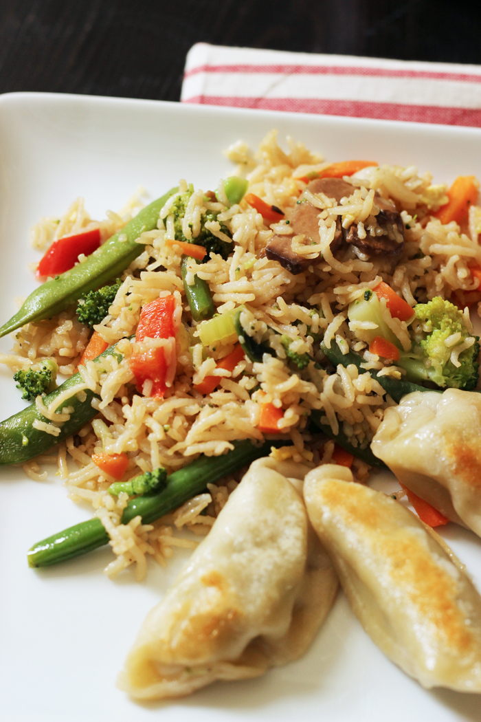 vegetable fried rice and pot stickers on a plate