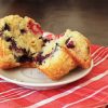 split berry muffin on saucer on red cloth