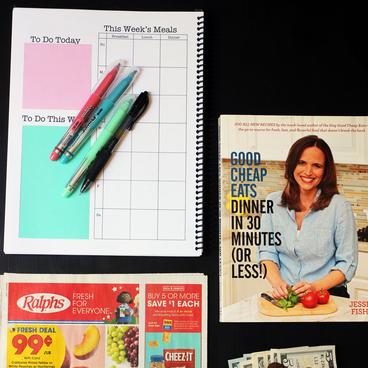 planner, grocery ad, cookbook, and money