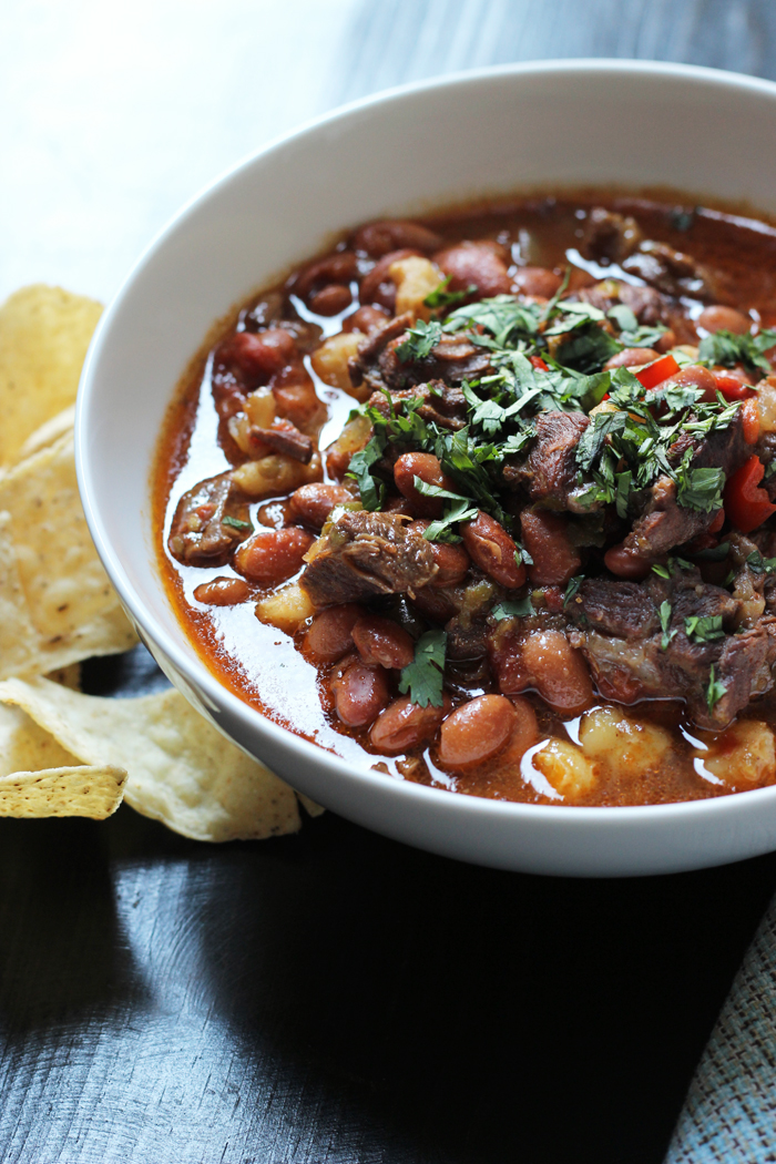 A bowl of Bean and Beef Stew, with chips