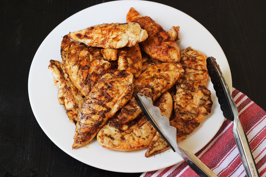 platter of spicy chicken with tongs