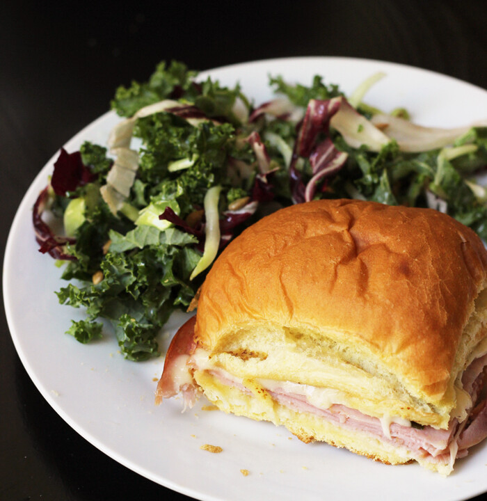 hot ham and swiss slider on plate with salad