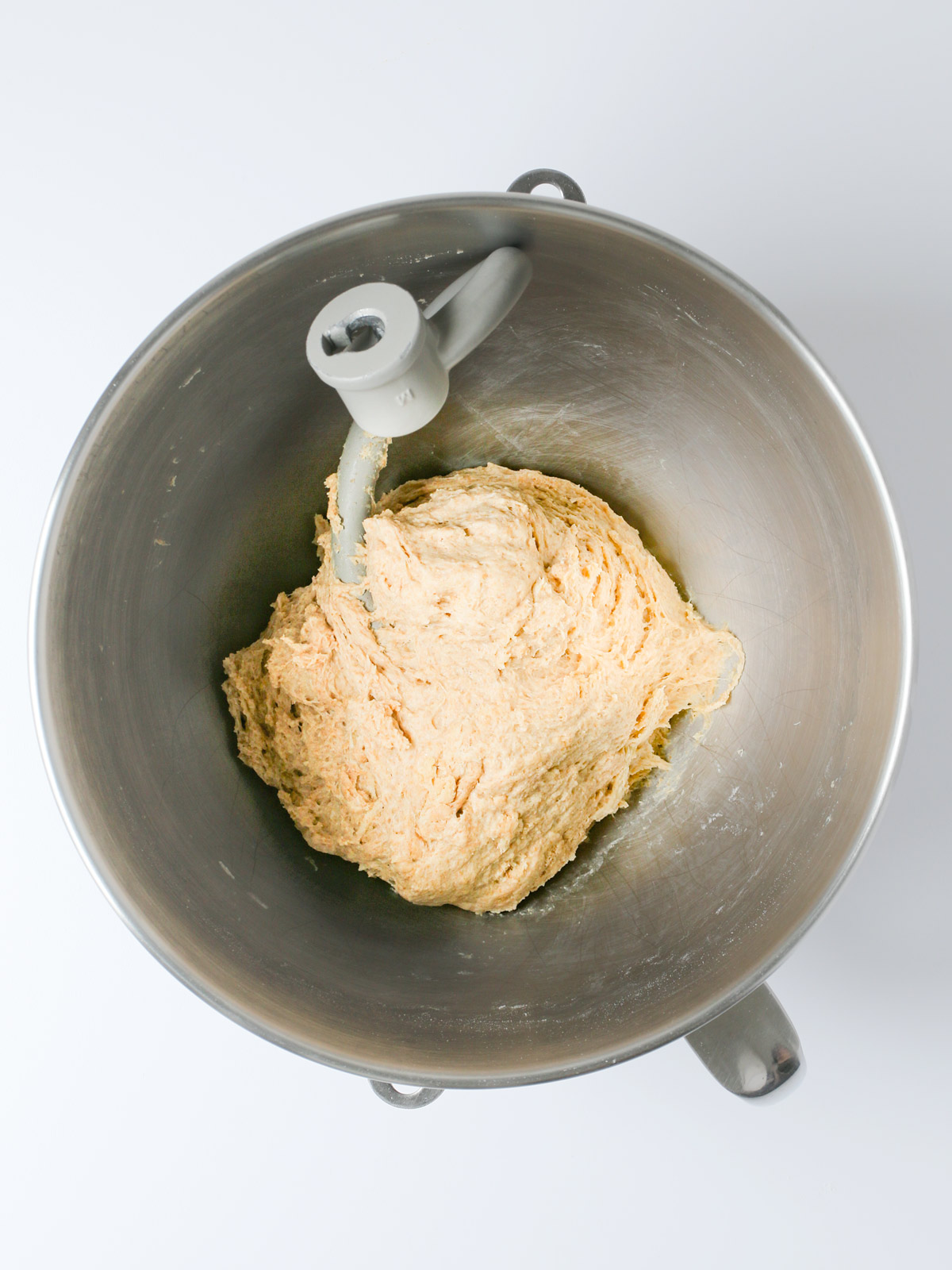dough ball formed with dough hook in mixer bowl.