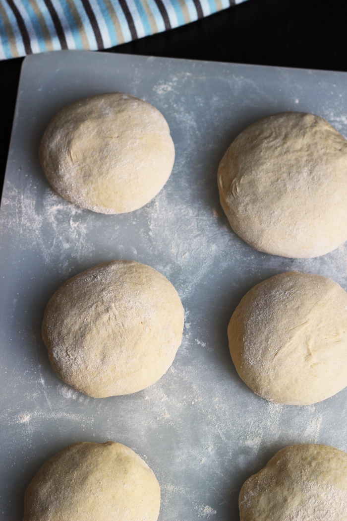 pizza dough balls on floured board