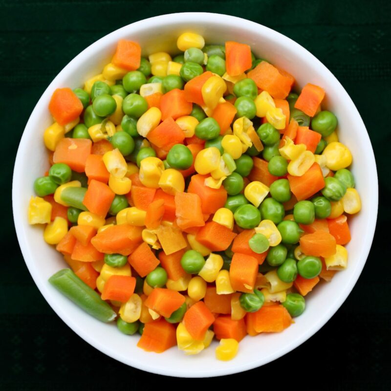 Creamy Hen Noodle Soup 1 mixed vegetables in a white bowl.