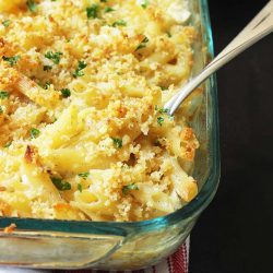 spoon digging into pan of Overnight casserole