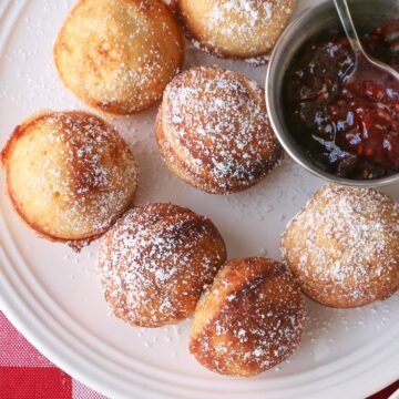 aebleskiver on plate with jam cup.