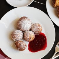 A close up of aebleskivers and sauce