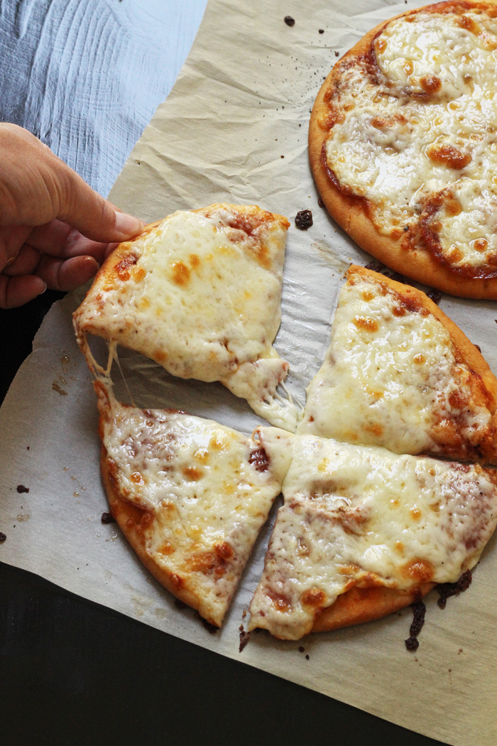 A sliced pizza sitting on top of a cutting board