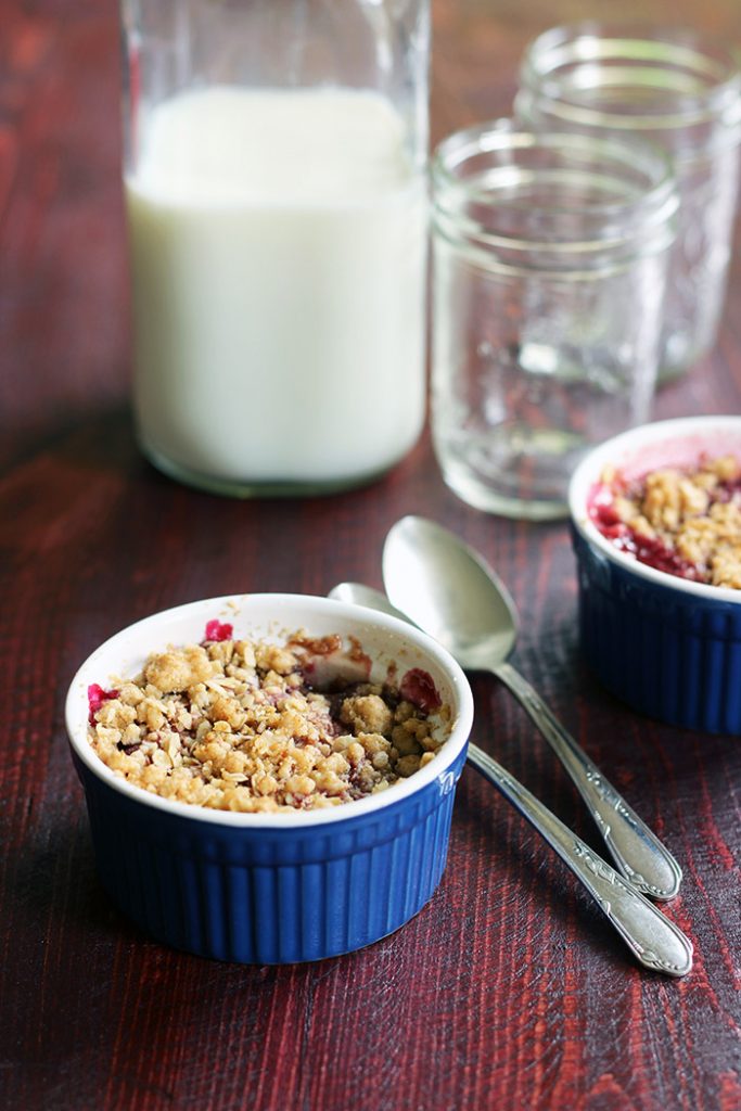 cherry crisp with milk jug and glasses
