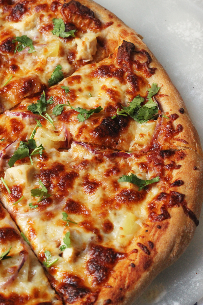 A close up of a slice of BBQ Chicken pizza