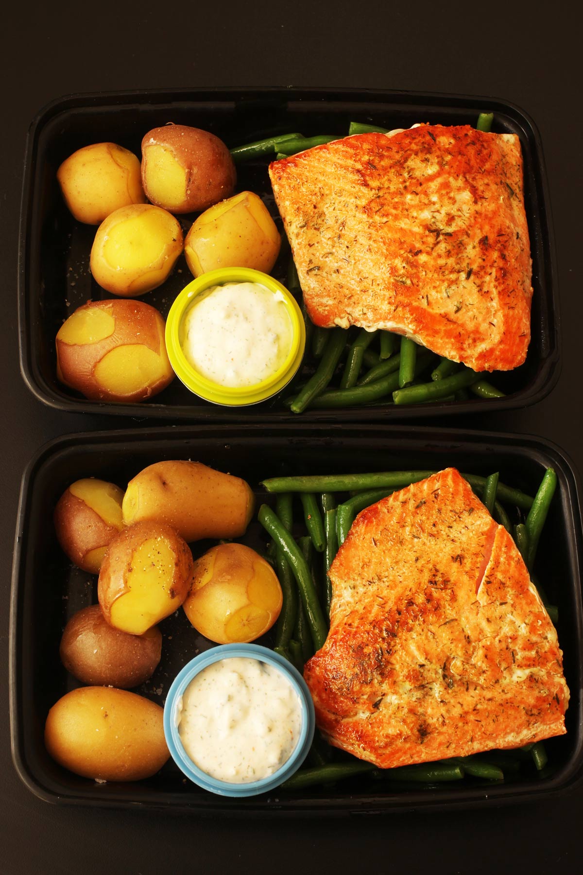 meal preps of fish with cups of tartar sauce