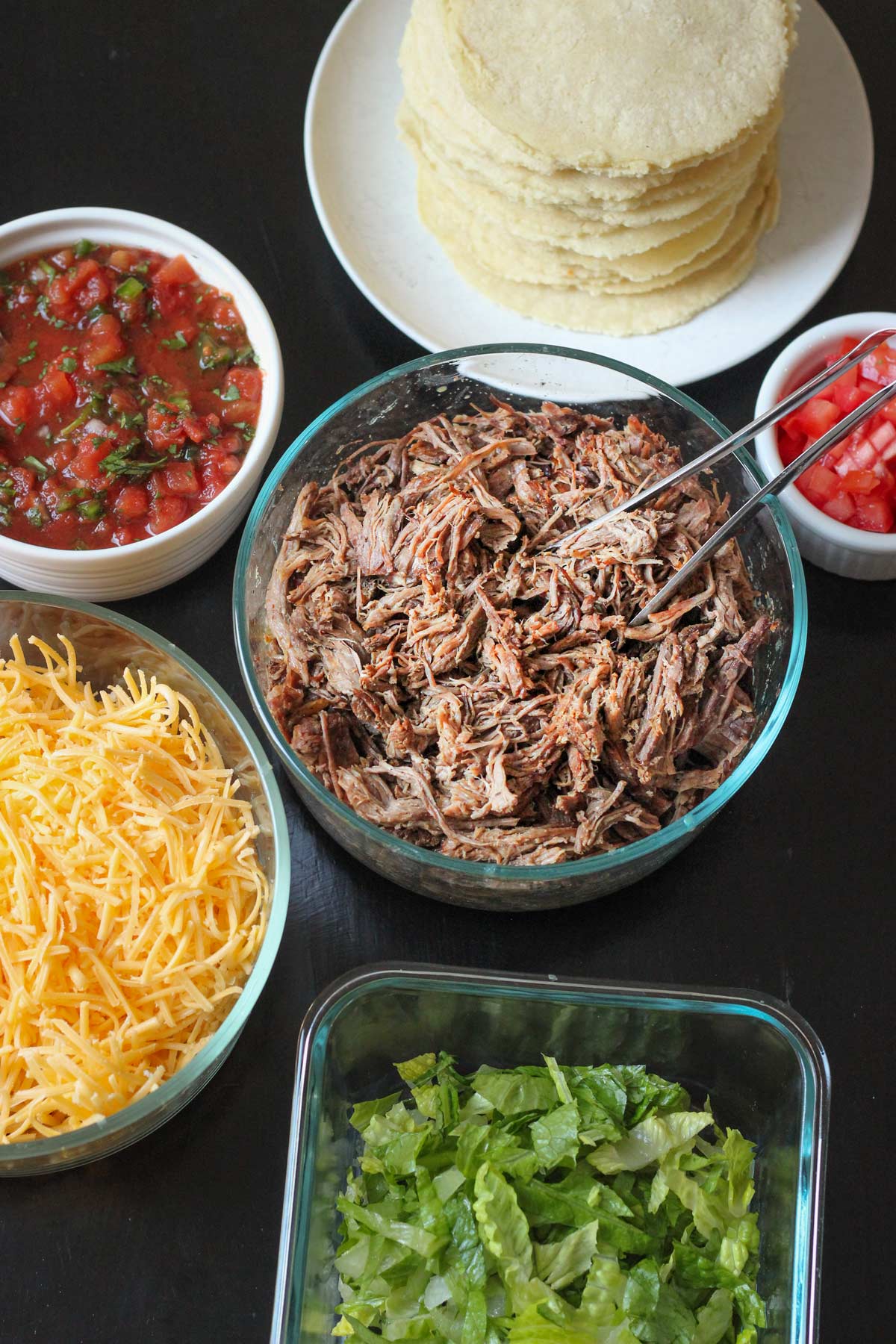 array of taco ingredients on the table.