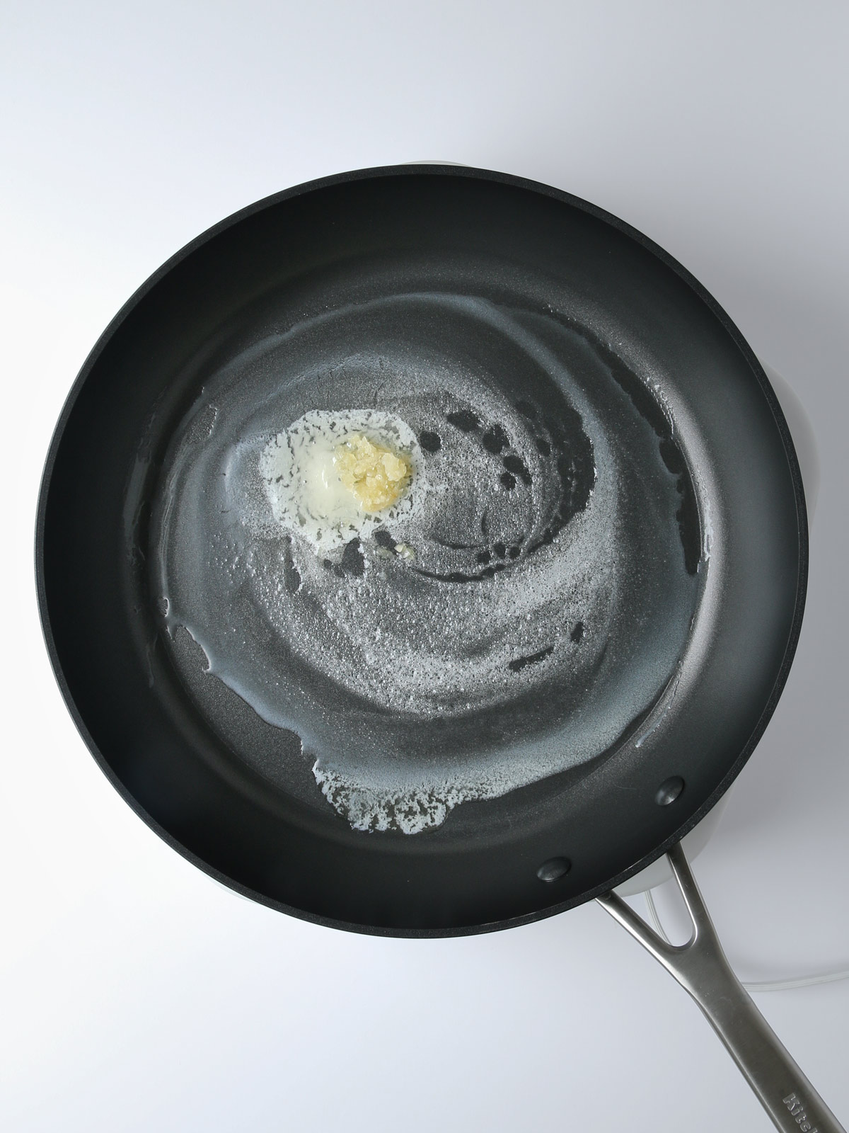 melting butter with garlic in a skillet.