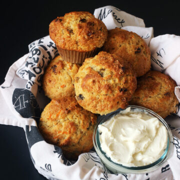 carrot muffins in basket with bowl of cream cheese