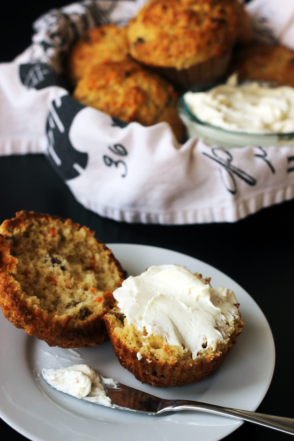 muffin on small plate with cream cheese spread