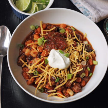 quick chili in a white bowl with toppings.