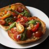 A plate of food, with pesto Bruschetta