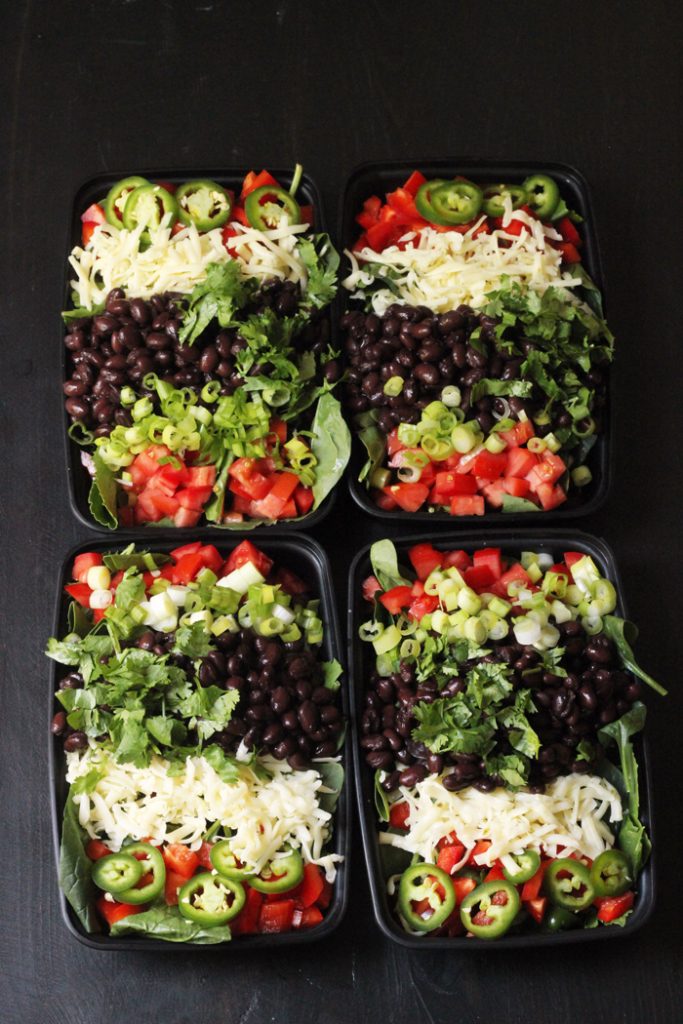 four black bean salads in to go containers