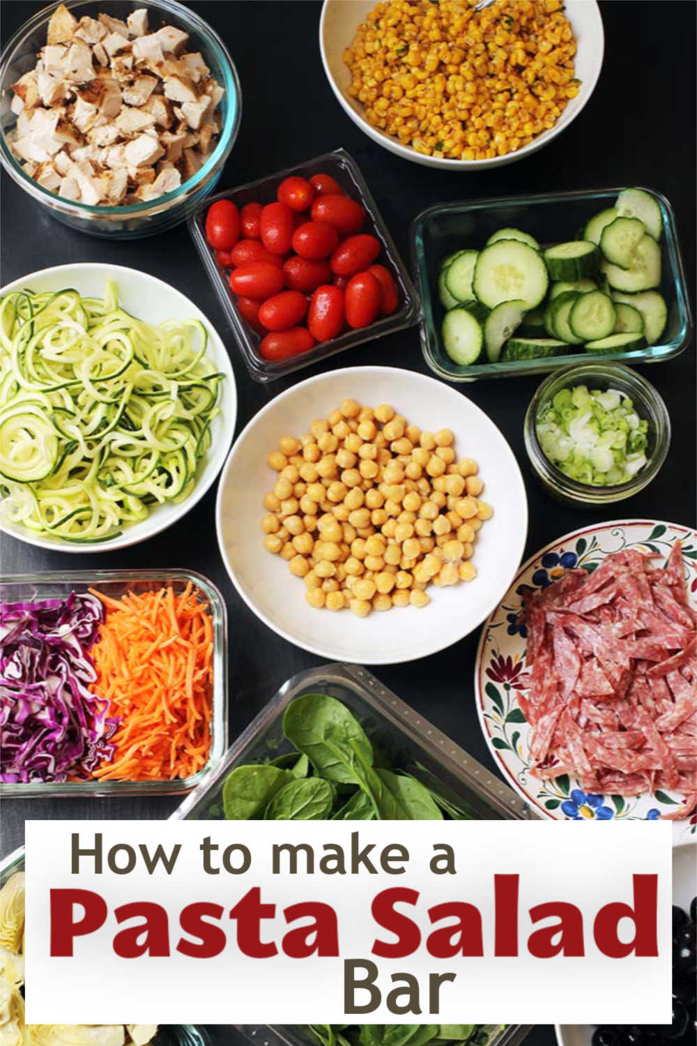 A bowl of pasta with many different types of food on a table