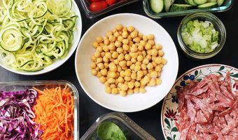 array of pasta salad toppings in different sized containers