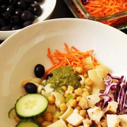 bowl of pasta with salad bar toppings in white bowl