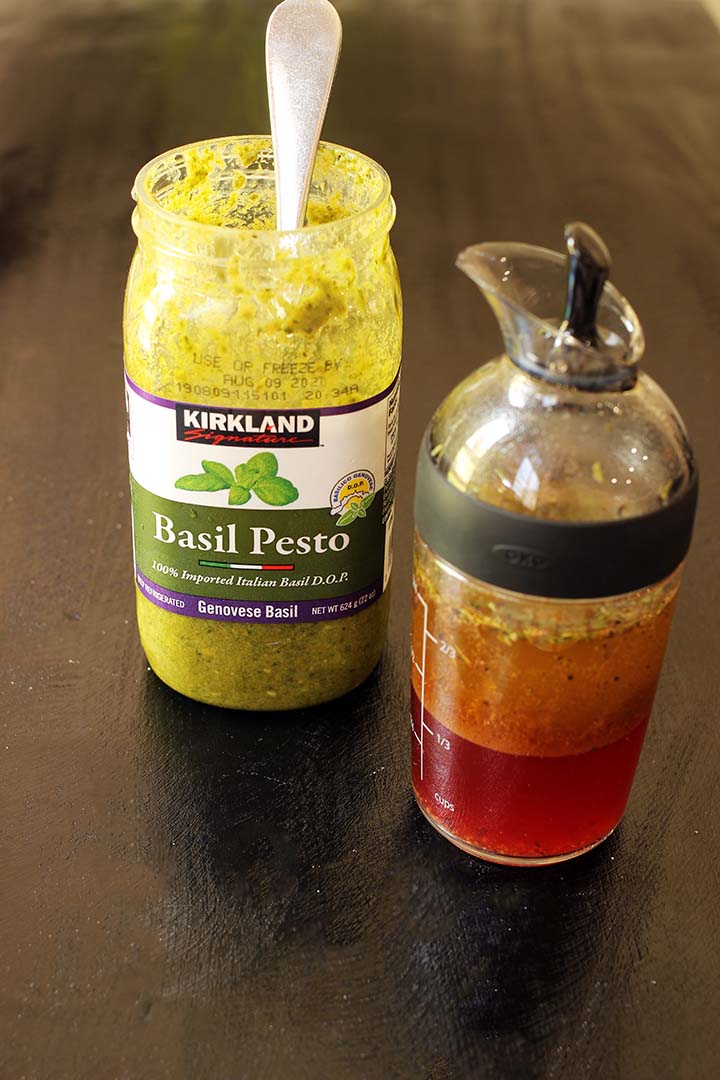 jar of pesto and salad dressing decantor on black table