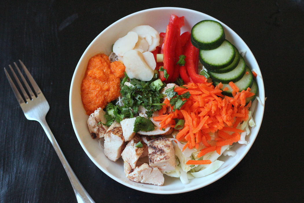 A bowl of chicken and Asian salad ingredients