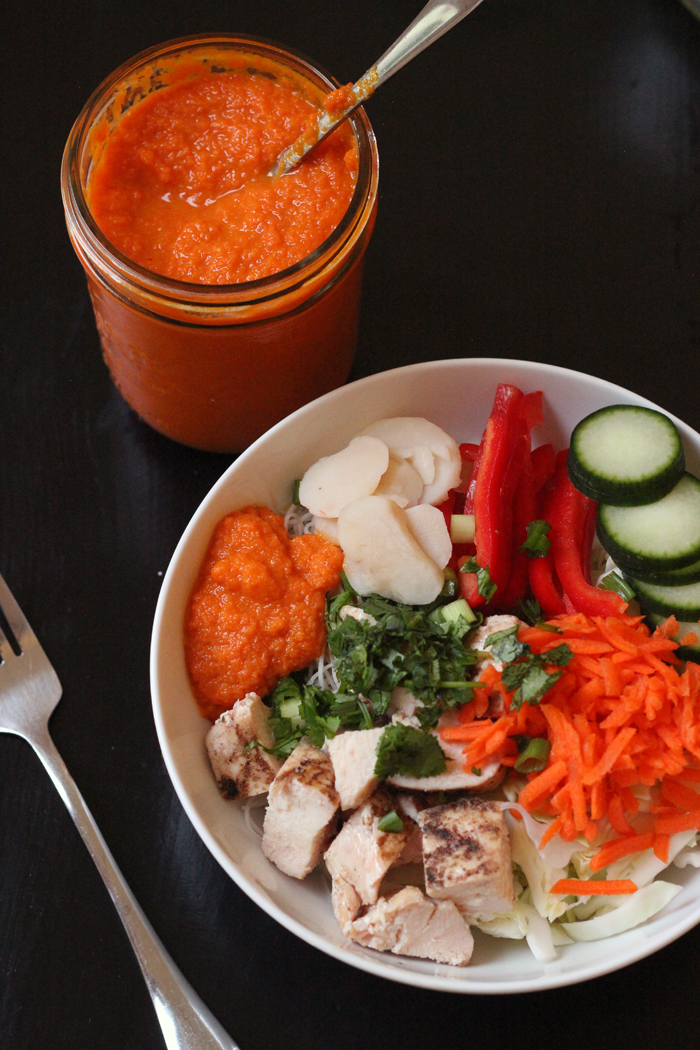 asian bowl with a mason jar of carrot ginger dressing