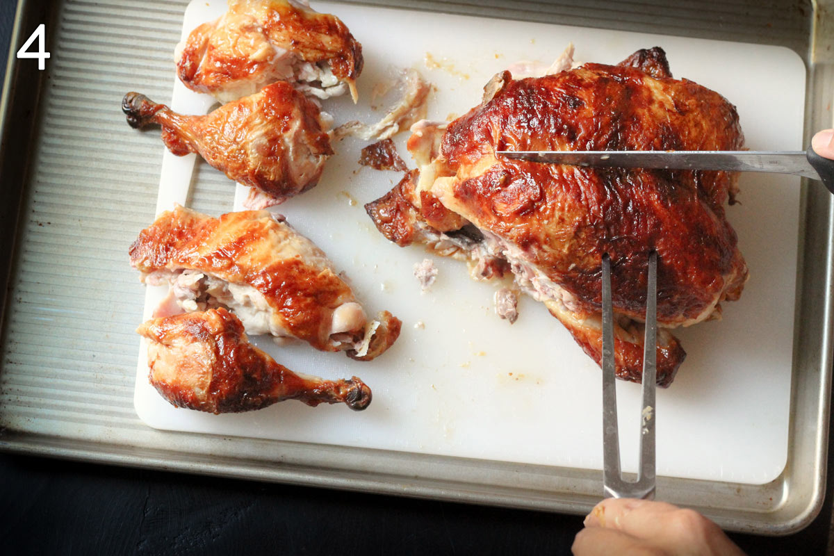 inserting knife into center of chicken breast to separate the two halves and remove from bone.