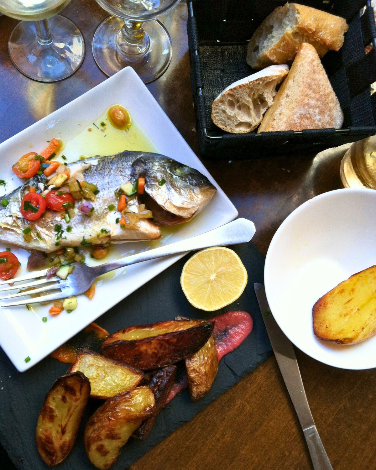 fish and potatoes on a platter at a french restaurant in collioure.