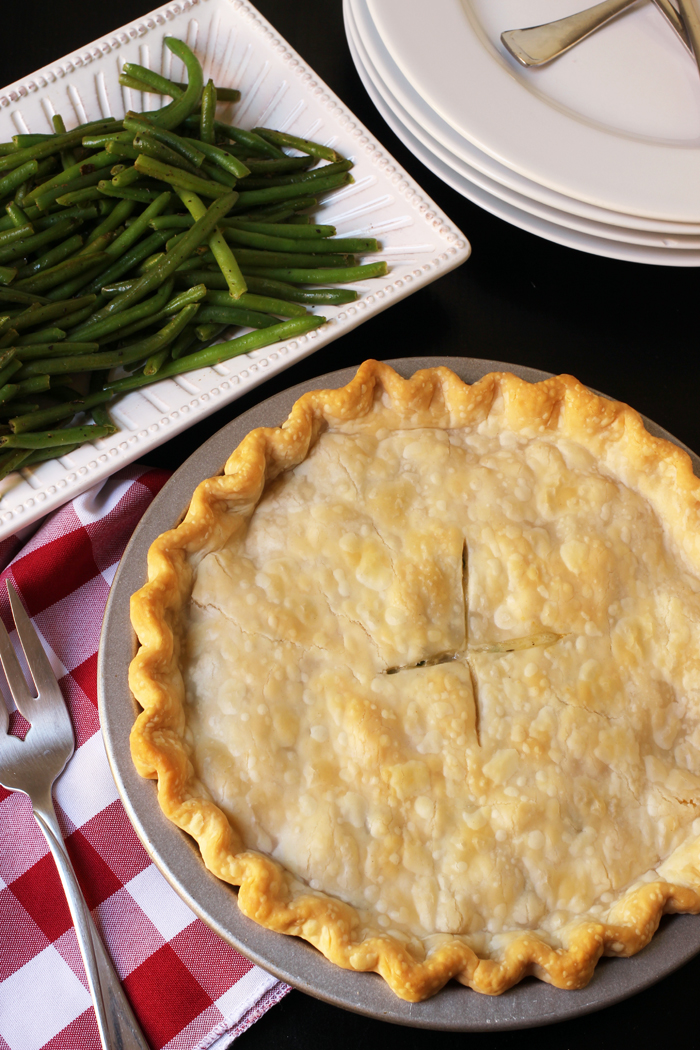 pot pie next to plate of green beans
