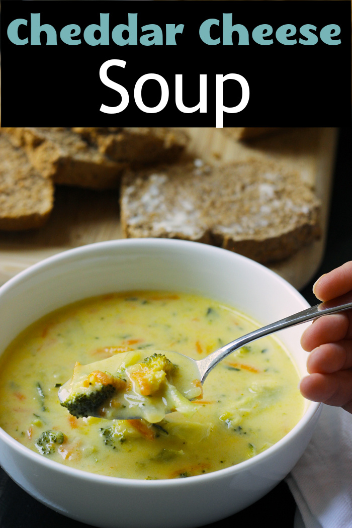 A bowl of Cheese soup and buttered bread