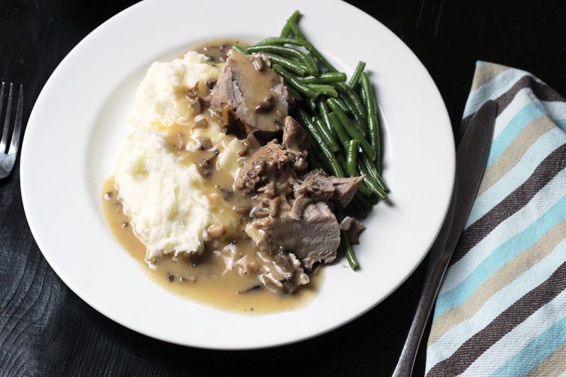 A plate of food on a table, with Gravy and Pork