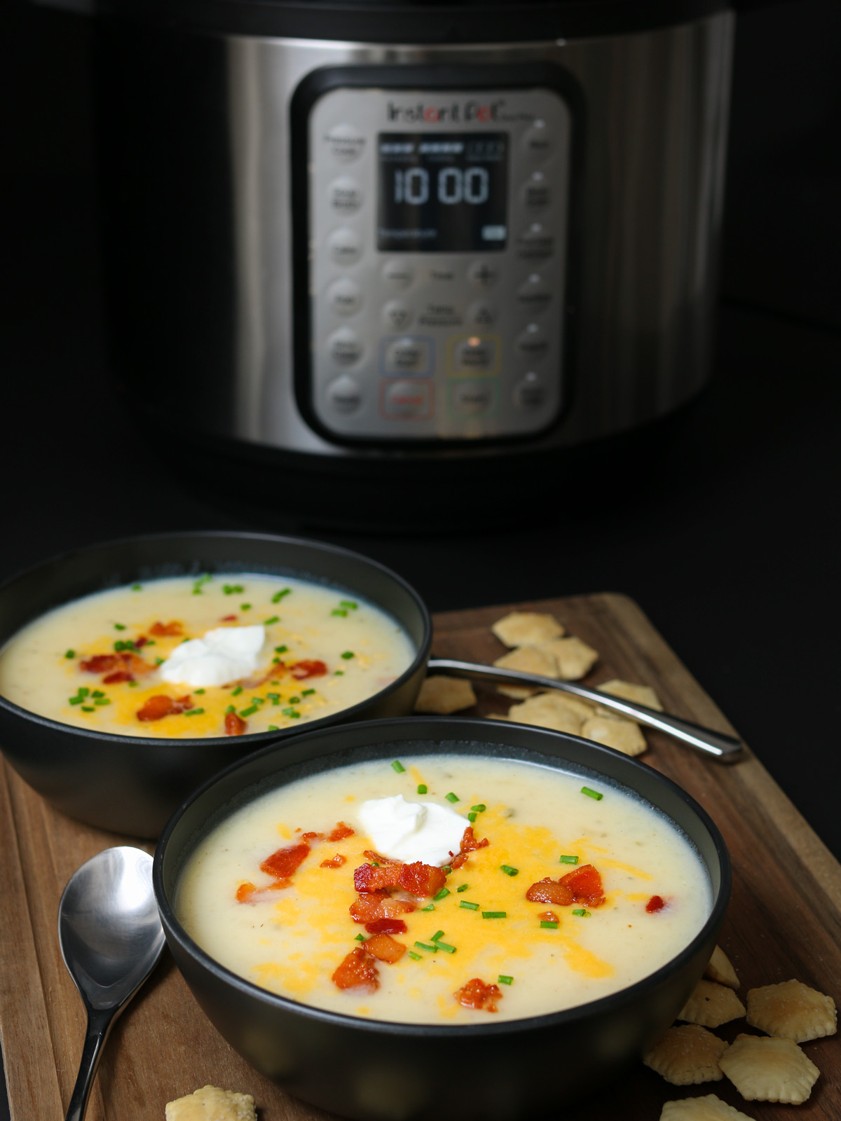 bowls of soup in front of instant pot on black table.