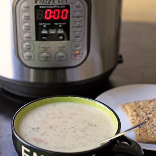bowl of broccoli soup next to pressure cooker