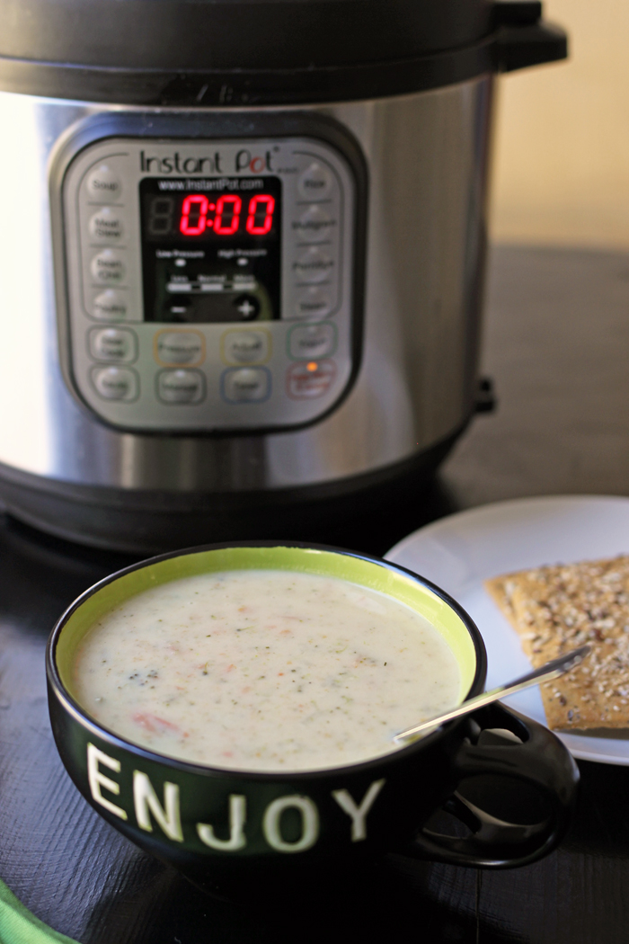 bowl of broccoli soup next to pressure cooker