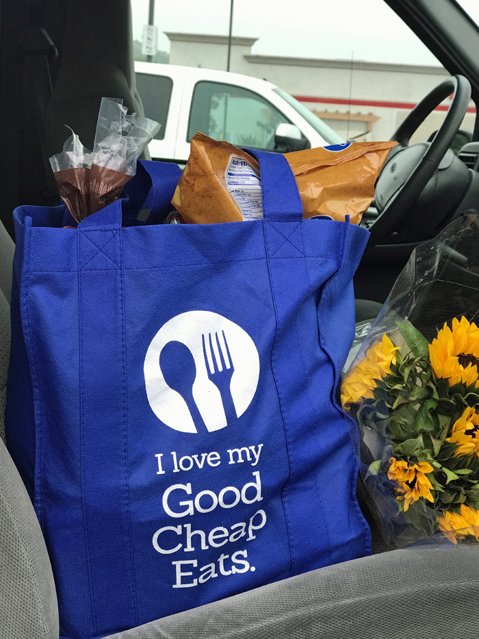 grocery bag and flowers on front seat of car
