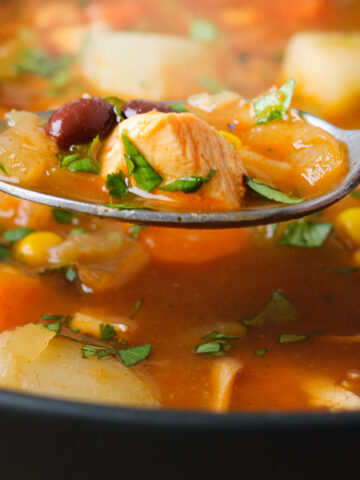 spoon of chicken taco soup over the bowl of soup.